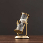 Antique hourglass made of brass with violet sand