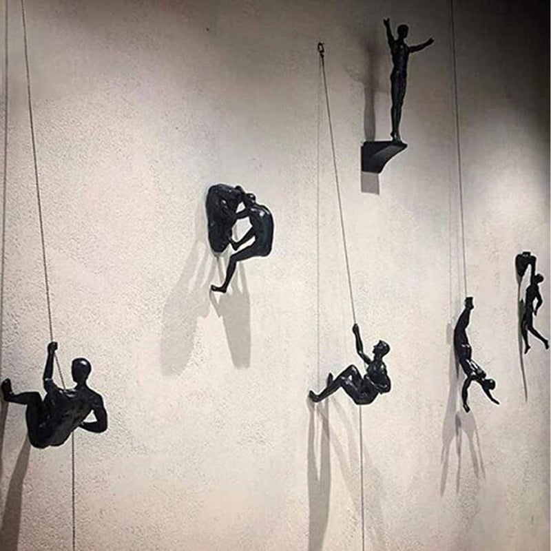 Climbing wall hanging statues