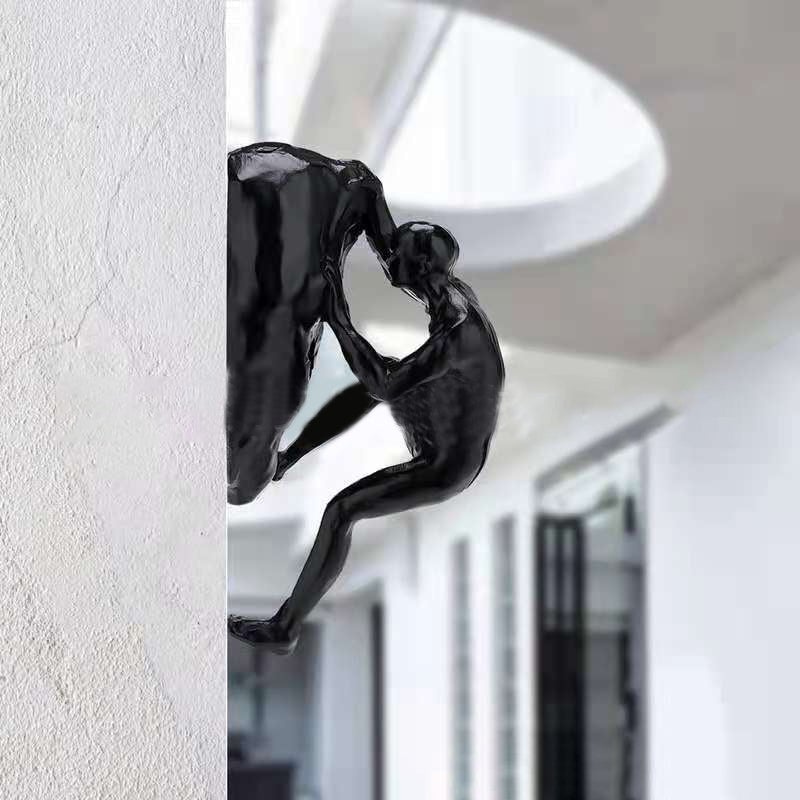 Climbing wall hanging statues