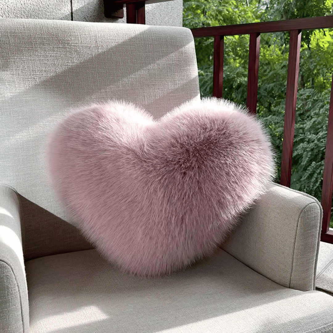 Soft decorative cushion in heart shape with plush texture