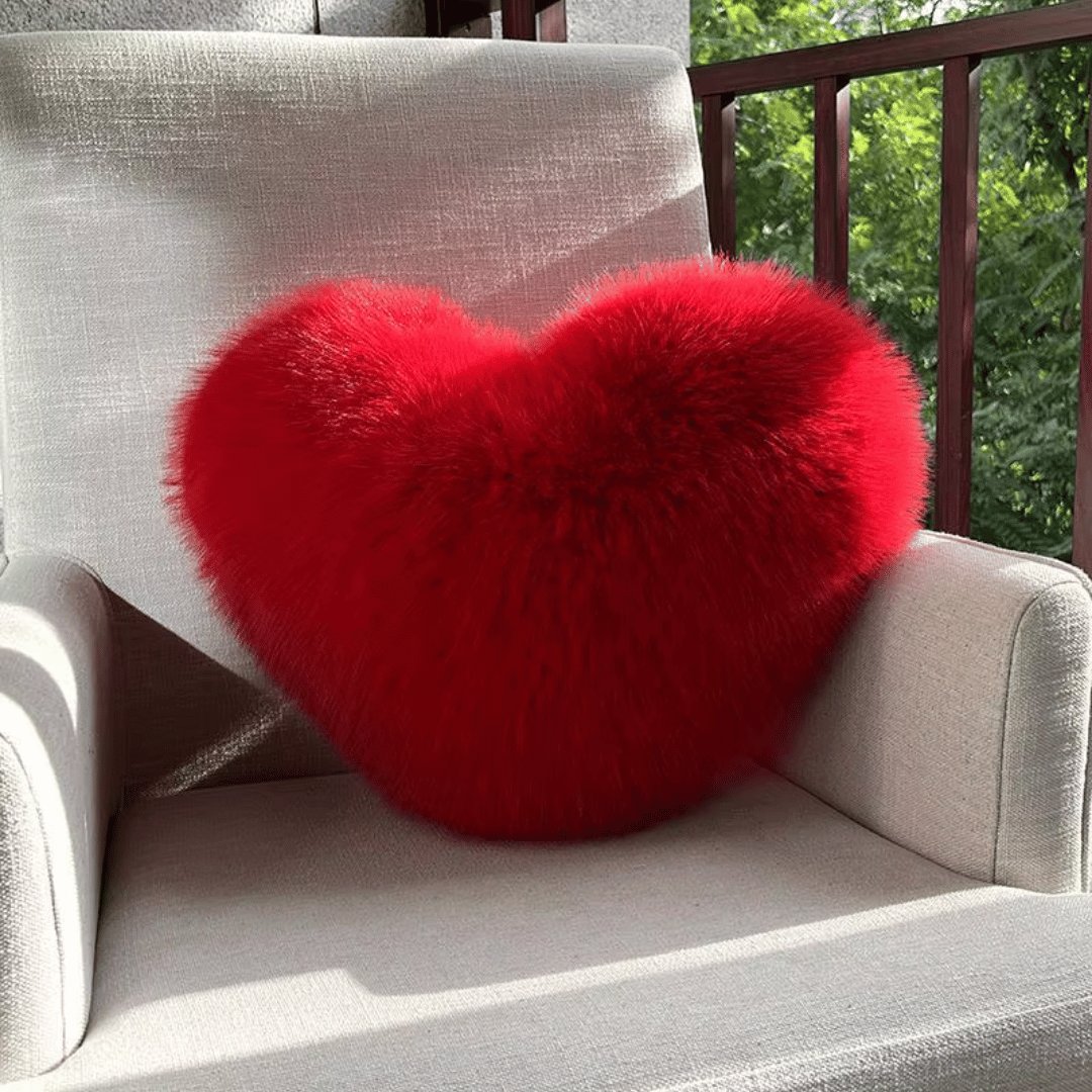 Soft decorative cushion in heart shape with plush texture
