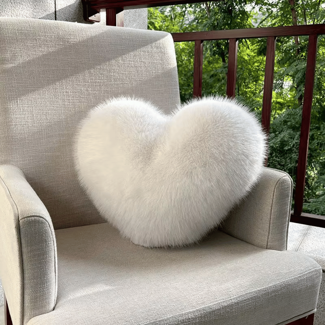 Soft decorative cushion in heart shape with plush texture