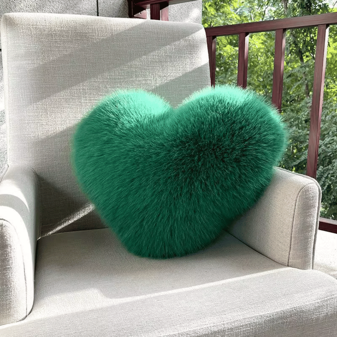 Soft decorative cushion in heart shape with plush texture