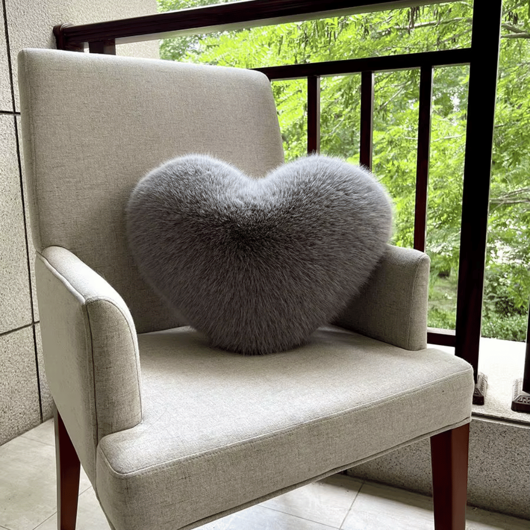 Soft decorative cushion in heart shape with plush texture