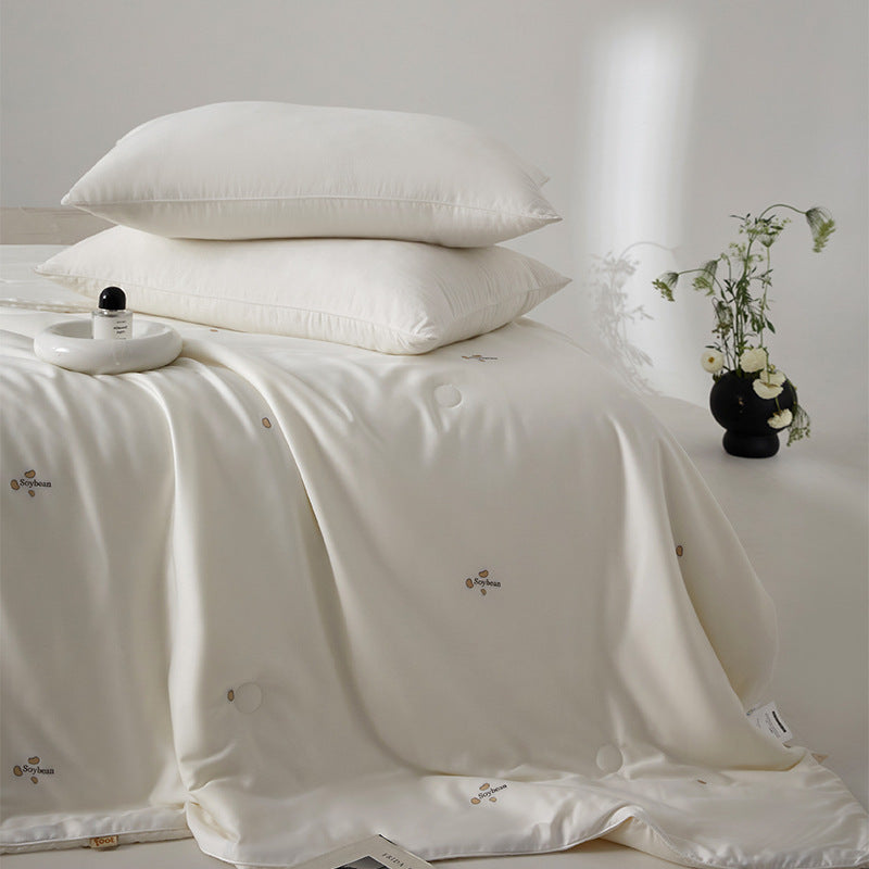 Silk bed cover made of microfiber with subtle embroidery and ultra-light fall