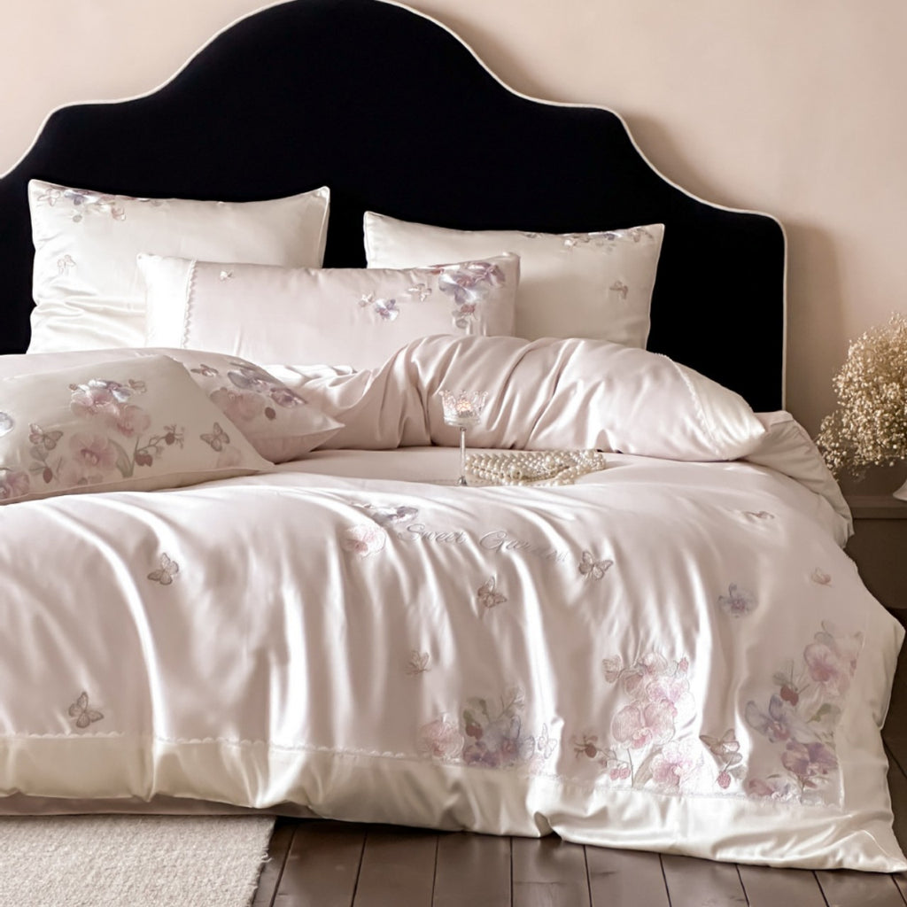 Luxurious satin bedding set with floral embroidery and butterfly appliqué