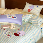 Children's bedding set made of cotton percale with striped design, appliquéd lettering, and playful dot appliqués