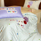 Children's bedding set made of cotton percale with striped design, appliquéd lettering, and playful dot appliqués