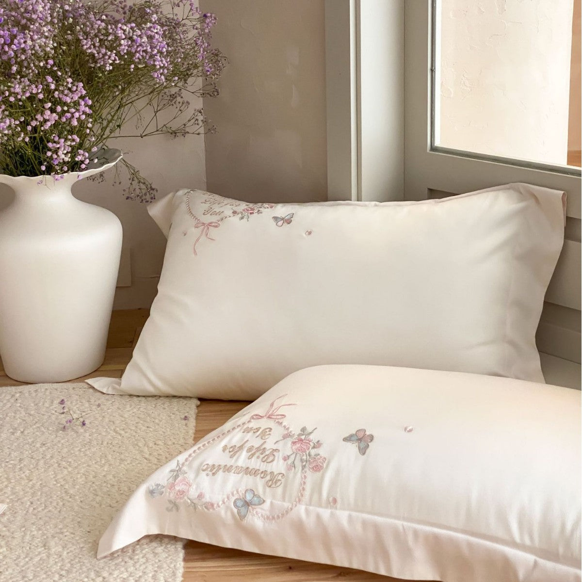 Luxurious embroidered cotton satin bedding set with delicate butterfly and flower appliqués