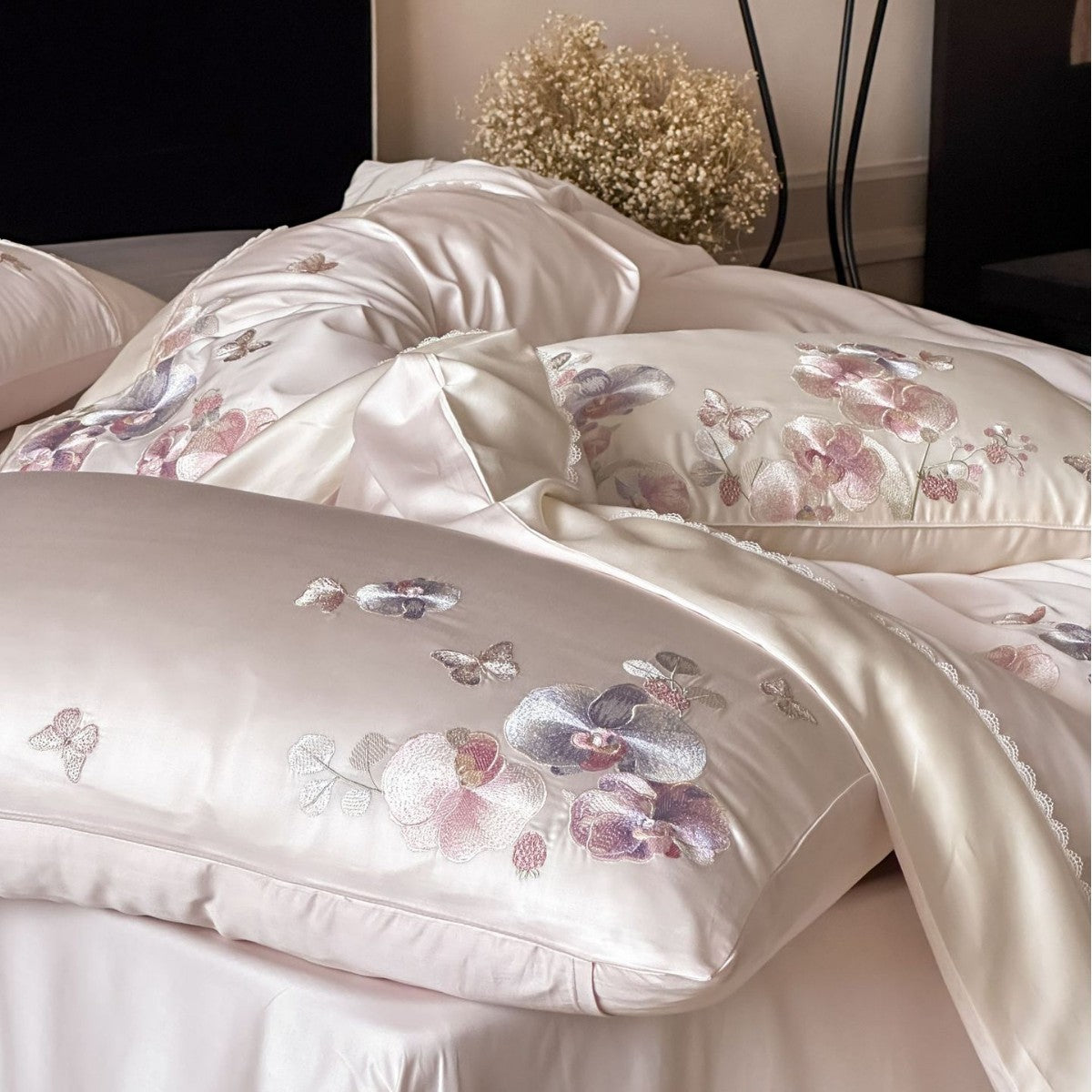 Luxurious satin bedding set with floral embroidery and butterfly appliqué