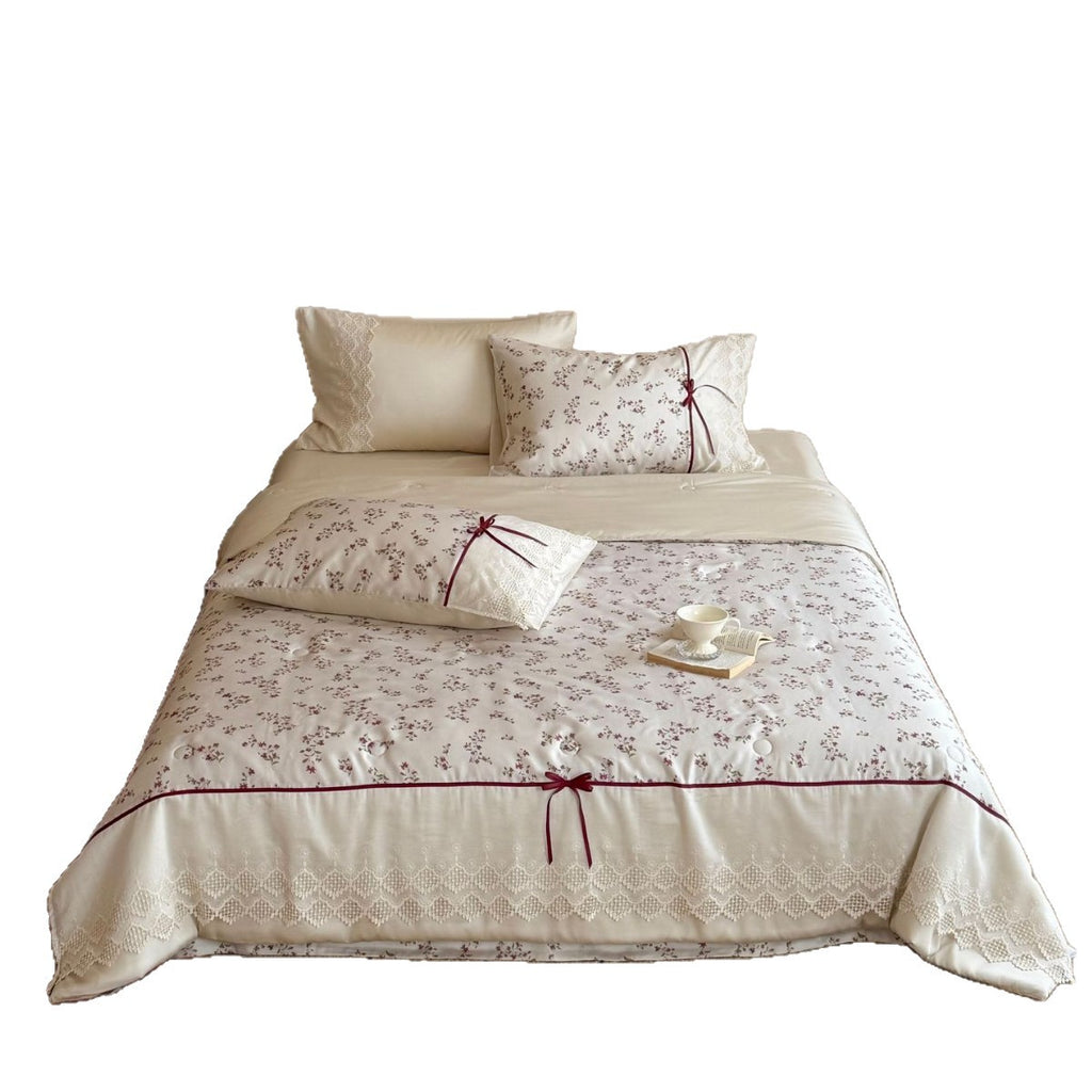 Luxurious cotton satin duvet cover set with lace trim, floral all-over embroidery, and decorative ribbons
