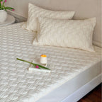 Padded mattress protector with quilted comfort layer and all-around elastic band