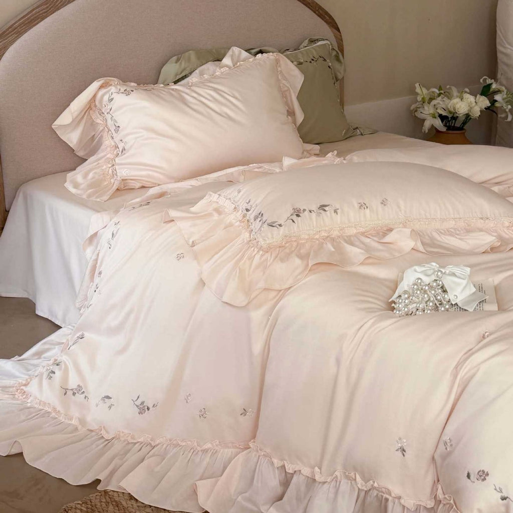 Elegant bedding set made of cotton satin with ruffles, delicate floral embroidery, and frills