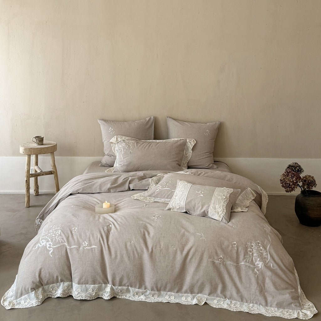 Vintage-inspired linen-cotton blend bedding set with floral chain stitch embroidery and lace trim