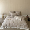 Vintage-inspired linen-cotton blend bedding set with floral chain stitch embroidery and lace trim