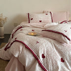 Quilted bedding set with heart and bow appliqué