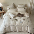 striped cotton bedding set with embroidered teddy bear appliqués and button closure