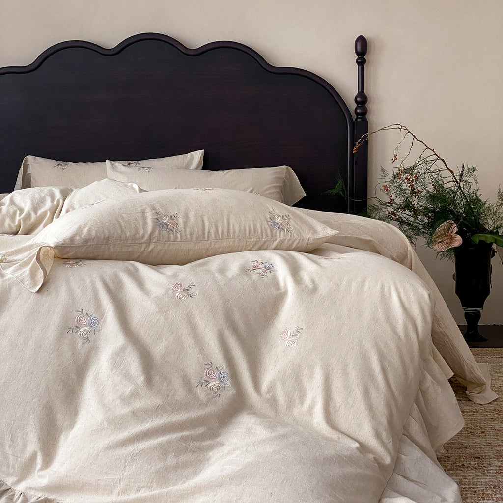 Vintage-inspired linen bedding set with fine rose embroidery and soft wash finish