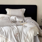 Luxurious cotton satin bed linen set with jacquard rose pattern and embroidered silhouette applications
