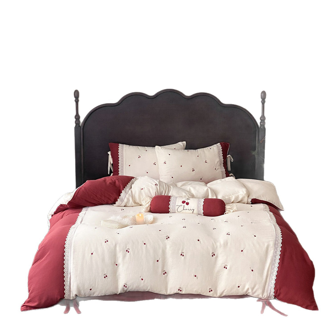 Country-style bedding set with cherry embroidery, lace trim, and decorative neck roll