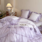 Romantic satin bedding set with layered ruffles and rose appliqués