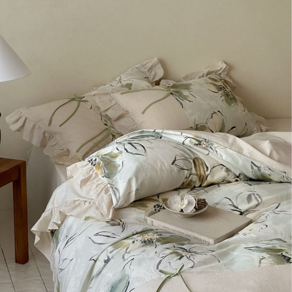 Duvet cover set made of cotton satin with watercolor magnolia print, ruffle, and tie ribbons