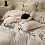 Home decor bedding set made of organic linen with hand-embroidered swallow motif and wavy hem