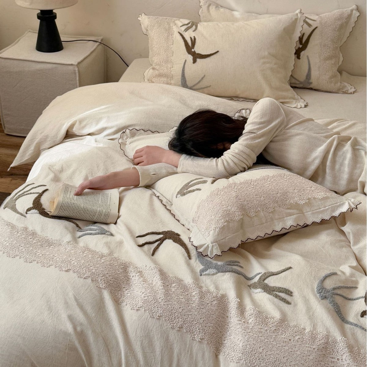 Home decor bedding set made of organic linen with hand-embroidered swallow motif and wavy hem