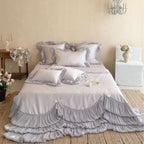 Romantic satin bedding and bedspread set with decorative ruffles and bows