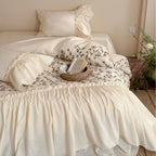 Bedding set with floral embroidered cover, gathered ruffle and cotton texture