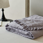 Light padded bedspread made of linen-cotton blend with gathered ruffle