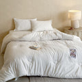 Quilted duvet with teddy applique and breathable microfiber filling