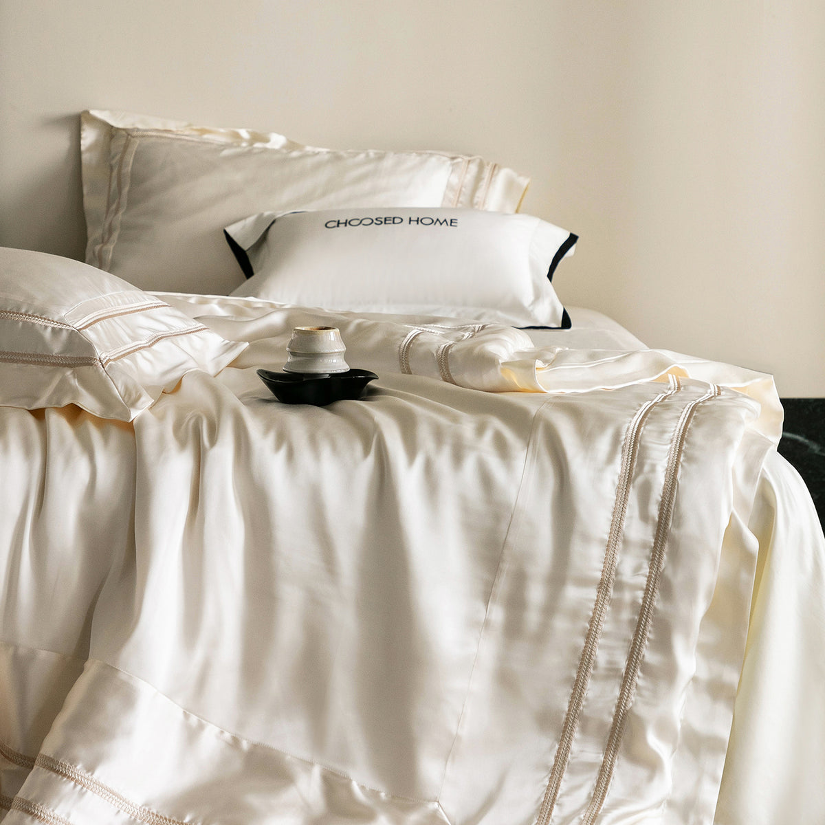 Luxurious satin bedding set with decorative borders and silky-smooth feel