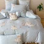 Playful children's bedding set made of silky-soft cotton satin with appliquéd bunnies and cuddly pillow