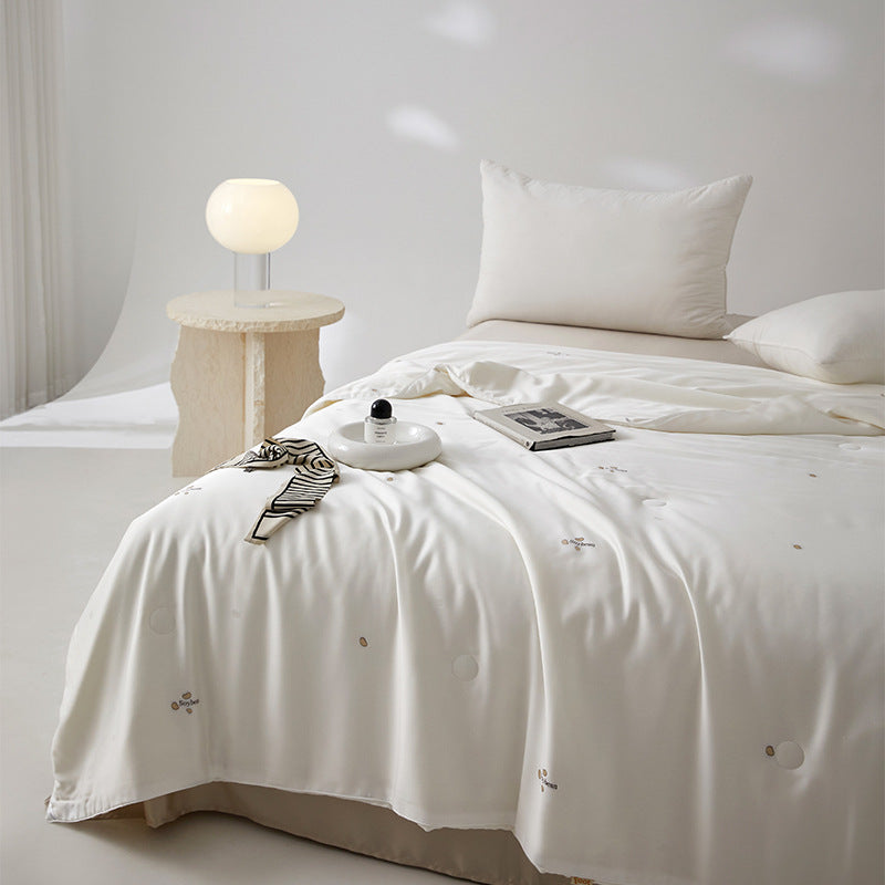Silk bed cover made of microfiber with subtle embroidery and ultra-light fall