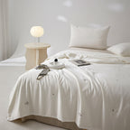Silk bed cover made of microfiber with subtle embroidery and ultra-light fall
