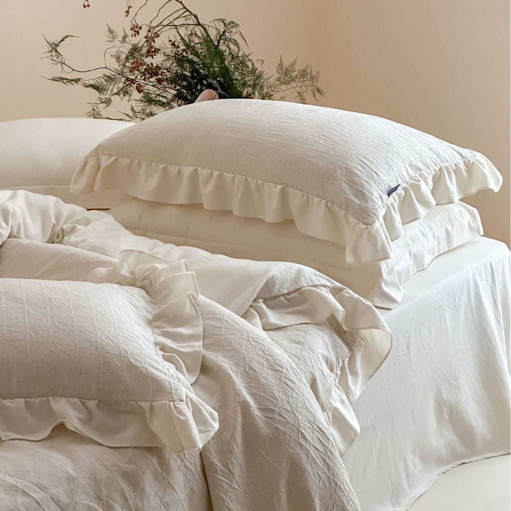 Quilted cotton-linen duvet cover set with subtle wrinkled texture and ruffle