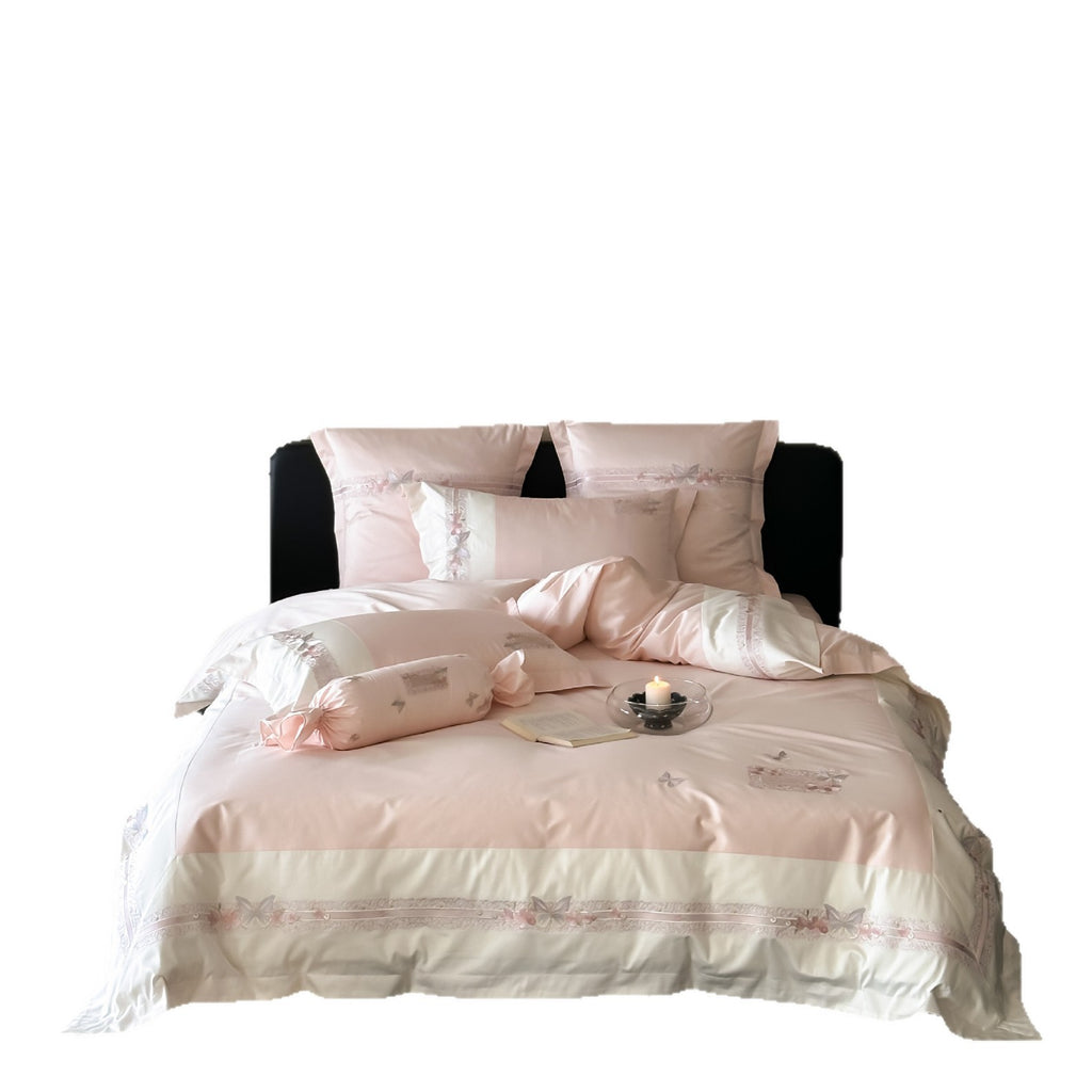 Luxurious cotton satin bed linen set with appliquéd flowers and decorative rolled hem