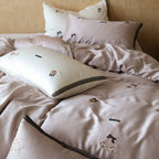 Bedding set made of premium satin with fine floral embroidery and piping edge