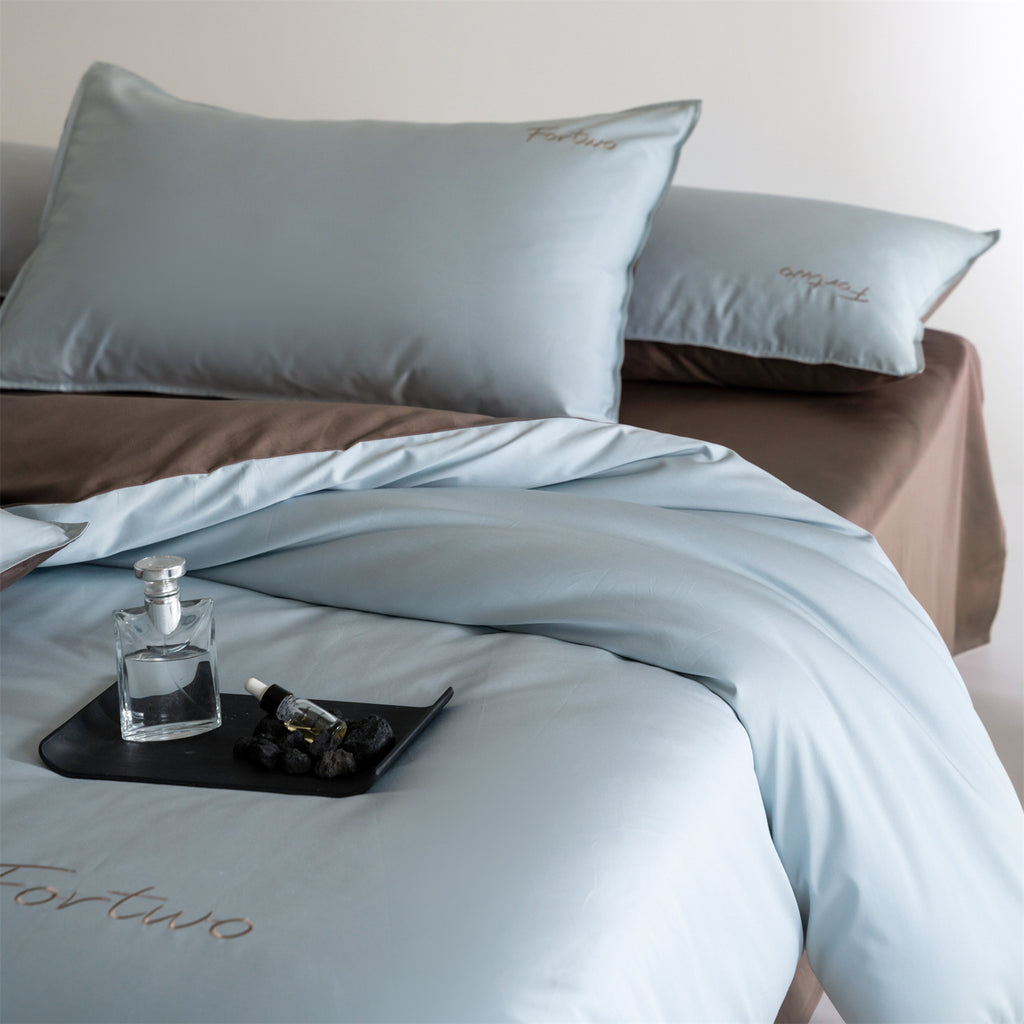Reversible satin bedding set with fine tone-on-tone embroidery