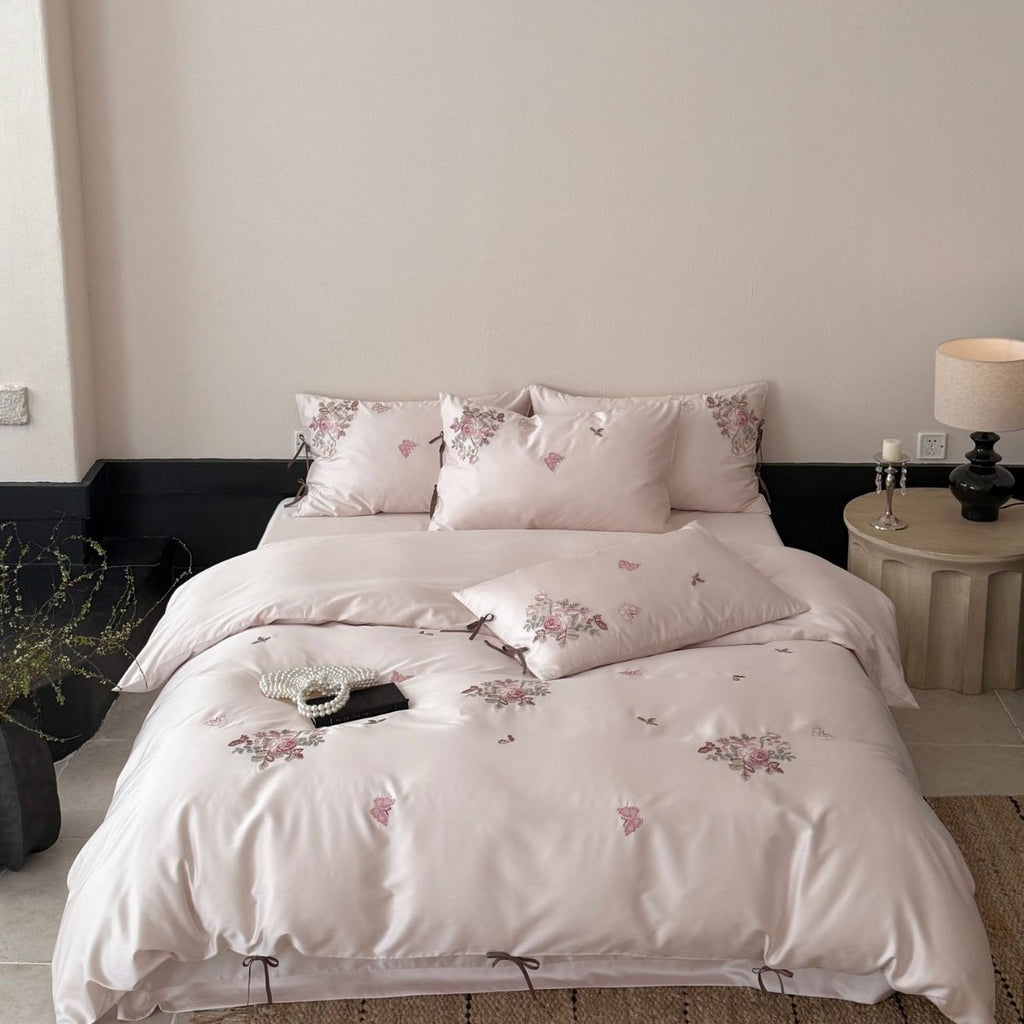 Silky-matte satin bedding set with embroidered rose bouquets and ties