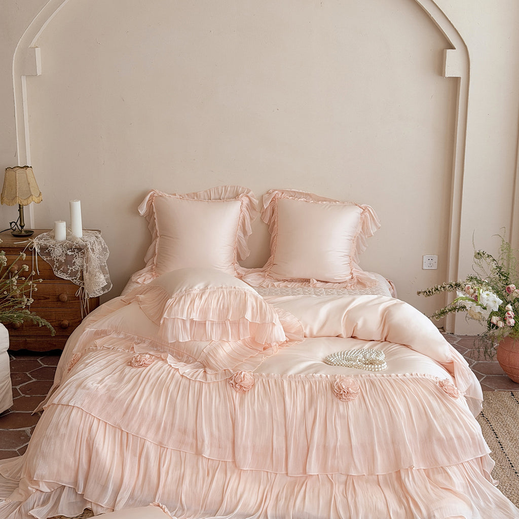 Romantic satin bedding set with layered ruffles and rose appliqués