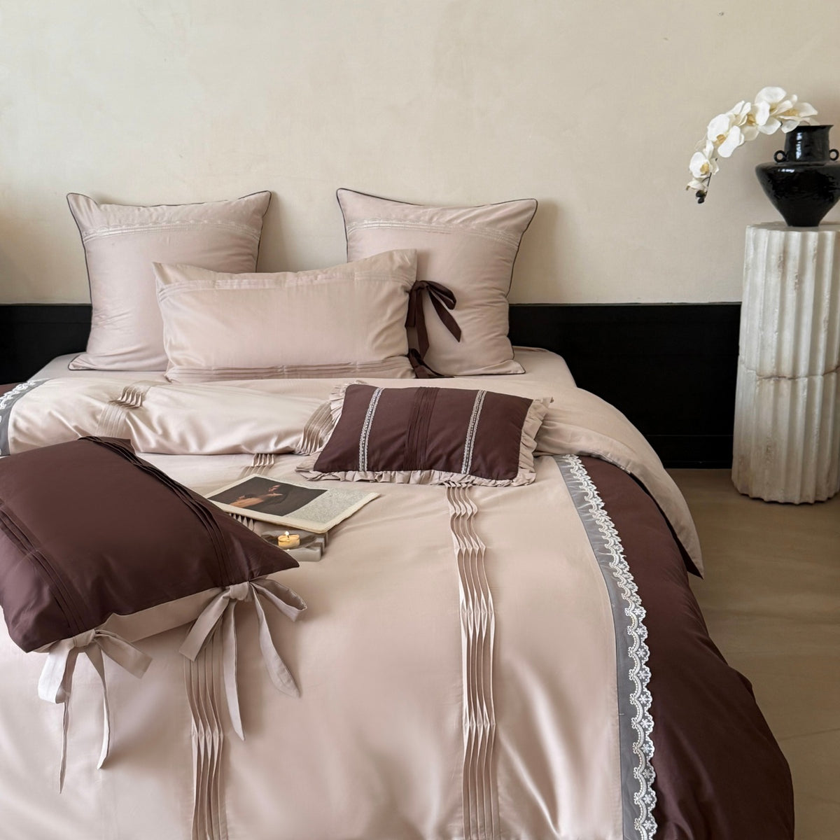 Elegant bedding set made of cotton satin with decorative pleats, bows, and lace trim