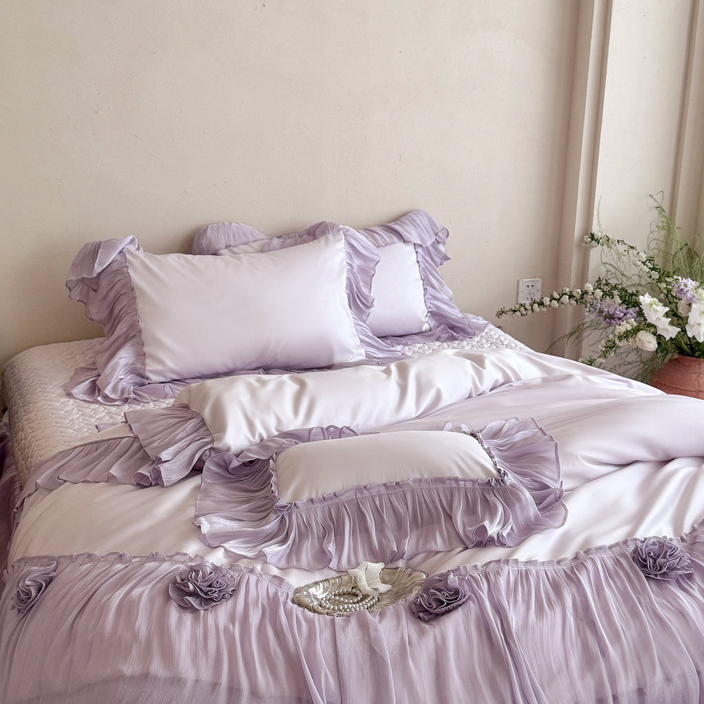 Romantic satin bedding set with layered ruffles and rose appliqués