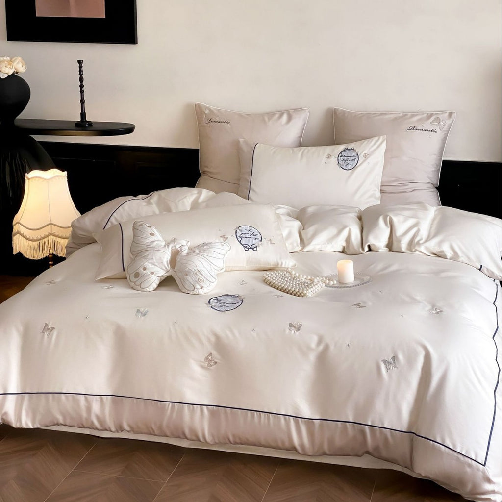 Luxurious cotton satin bedding set with embroidered butterfly appliqués and fine piping