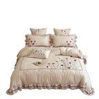 Bedding set made of cotton with floral embroidery and playful ruffle hem