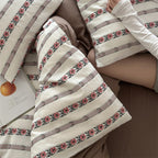 Breathable cotton bedding set with striped floral border and fitted sheet