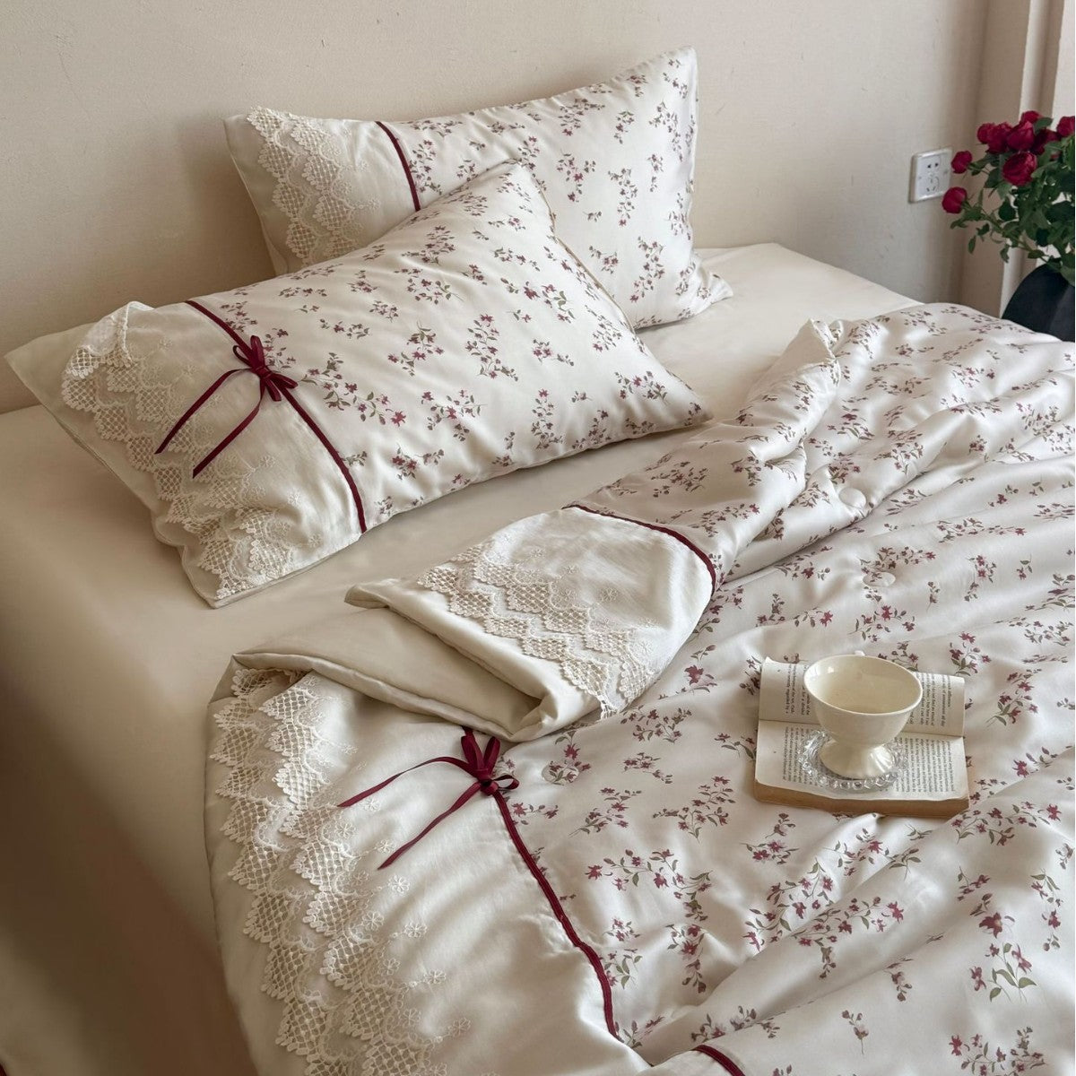 Luxurious cotton satin duvet cover set with lace trim, floral all-over embroidery, and decorative ribbons