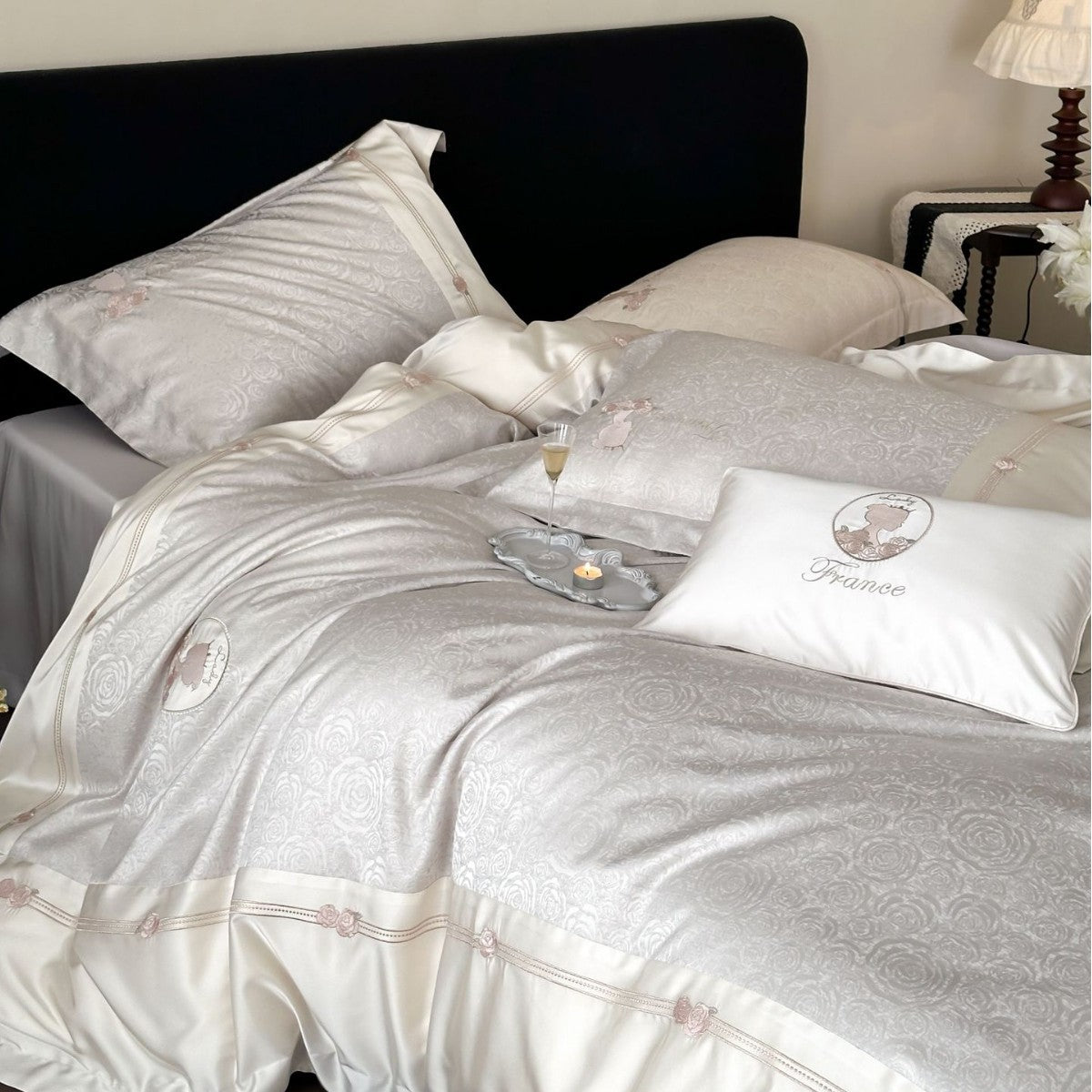 Luxurious cotton satin bed linen set with jacquard rose pattern and embroidered silhouette applications