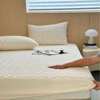 Padded mattress protector with quilted comfort layer and all-around elastic band